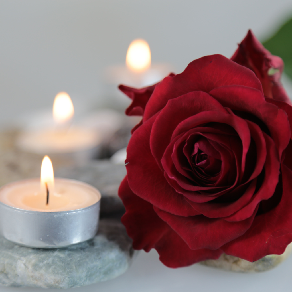 Coping with Grief: A rose and candles on rocks