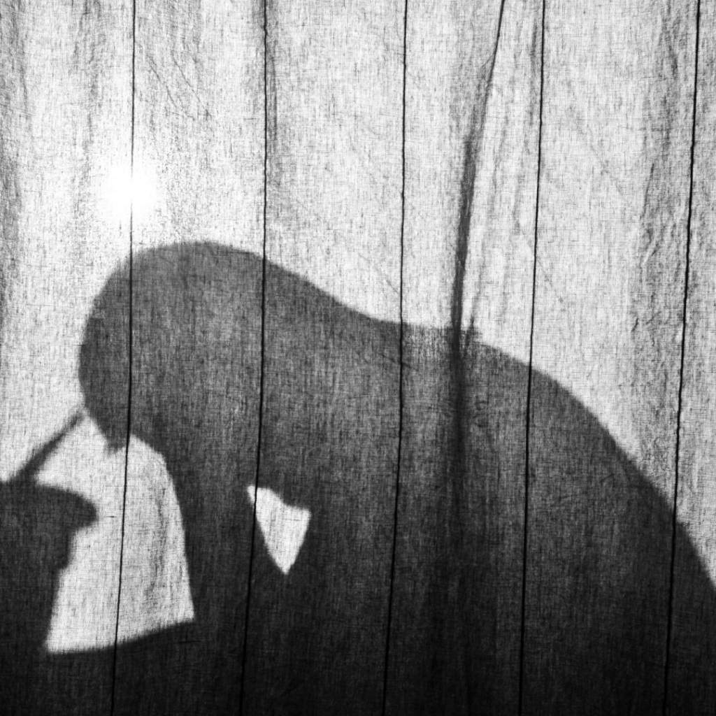 Are you living a life of desperation: Silhouette of a man with head bowed.